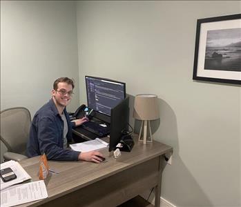 Tyler, shown at his desk, handles reconstruction projects!